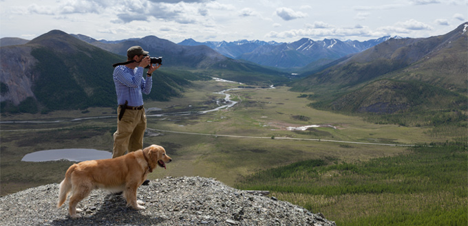 man hiking with his dog