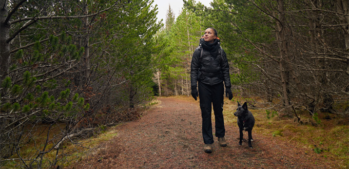 woman hiking with her dog