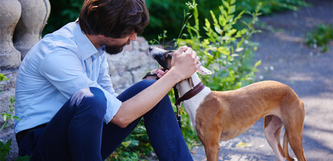 man petting his dog