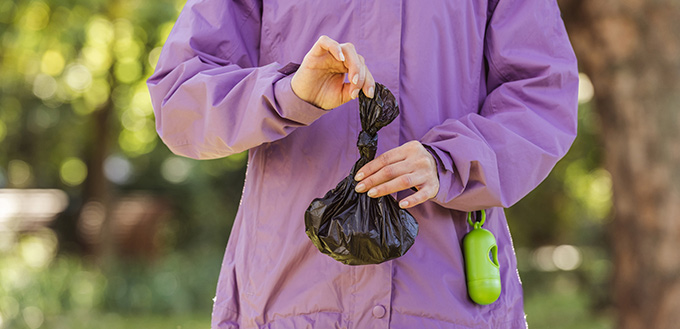 woman holding trash bag