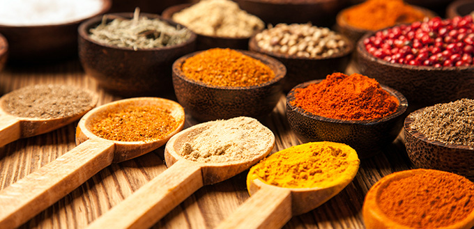 Spices and herbs in wooden bowls