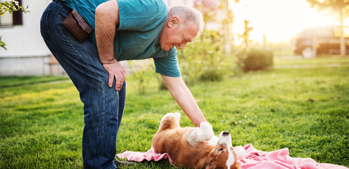 older man with a puppy