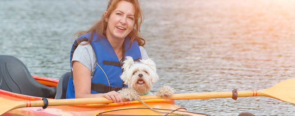 Woman and her dog on a kayak