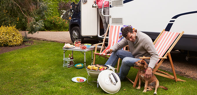 Couple In Van Enjoying Barbeque