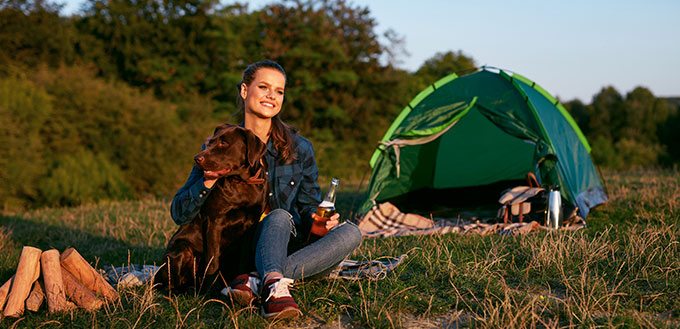 Happy Woman Camping With Dog