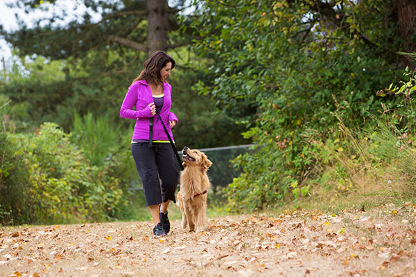 A pretty woman walking her dog