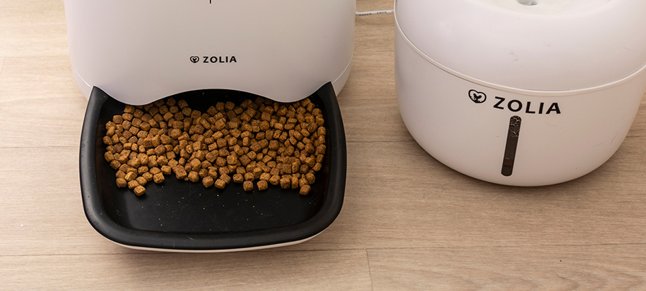  A automatic pet food dispenser and a pet water fountain on the floor