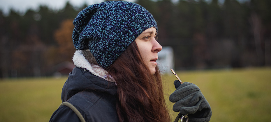 Detail on the attention of a brunette who whistles a disobedient dog