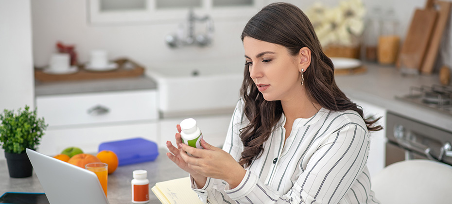 New supplement Dark-haired woman in a striped blouse looking interested