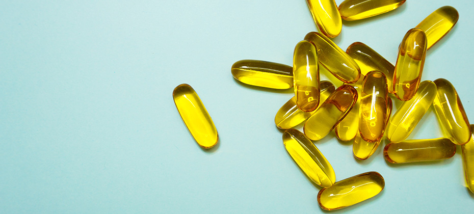 fish oil Omega 3 capsules on the blue background